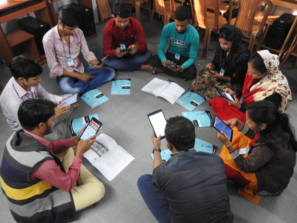 Participants with tablets during a group training session