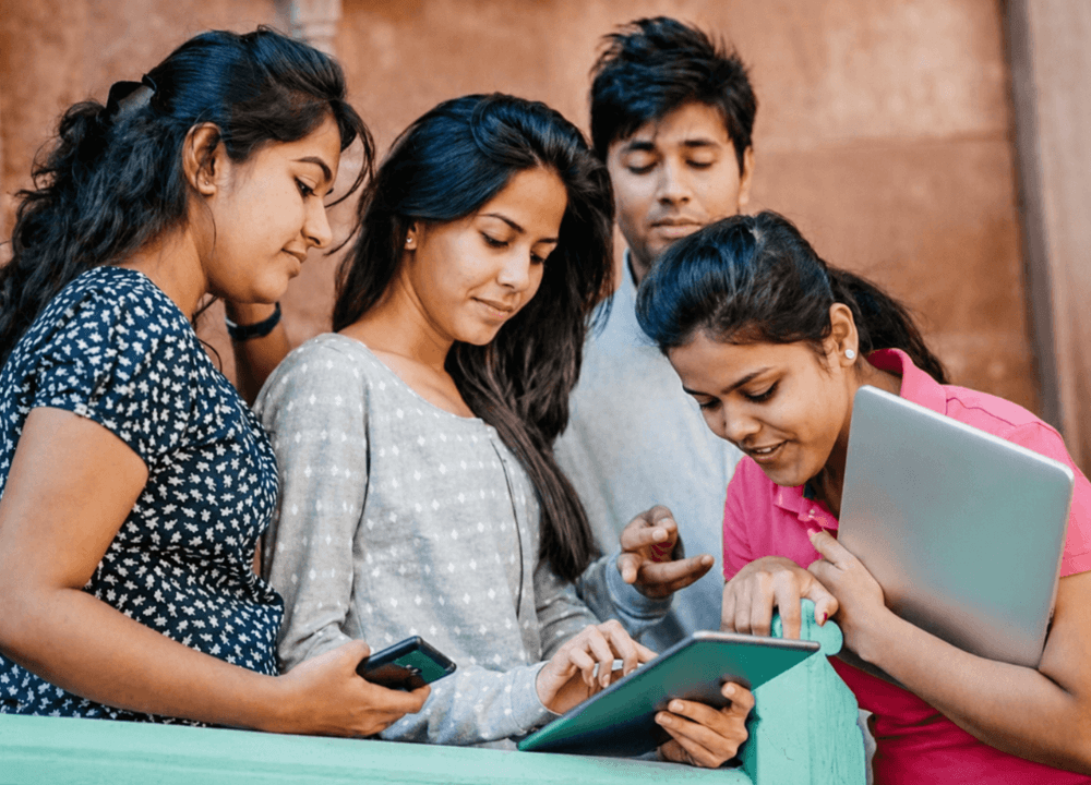 Young students learning together on a tablet and phones